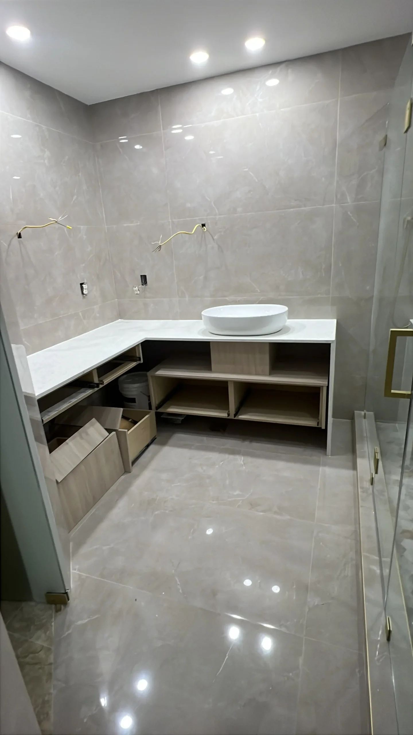 Bathroom vanity and sink with tiled wall backsplash